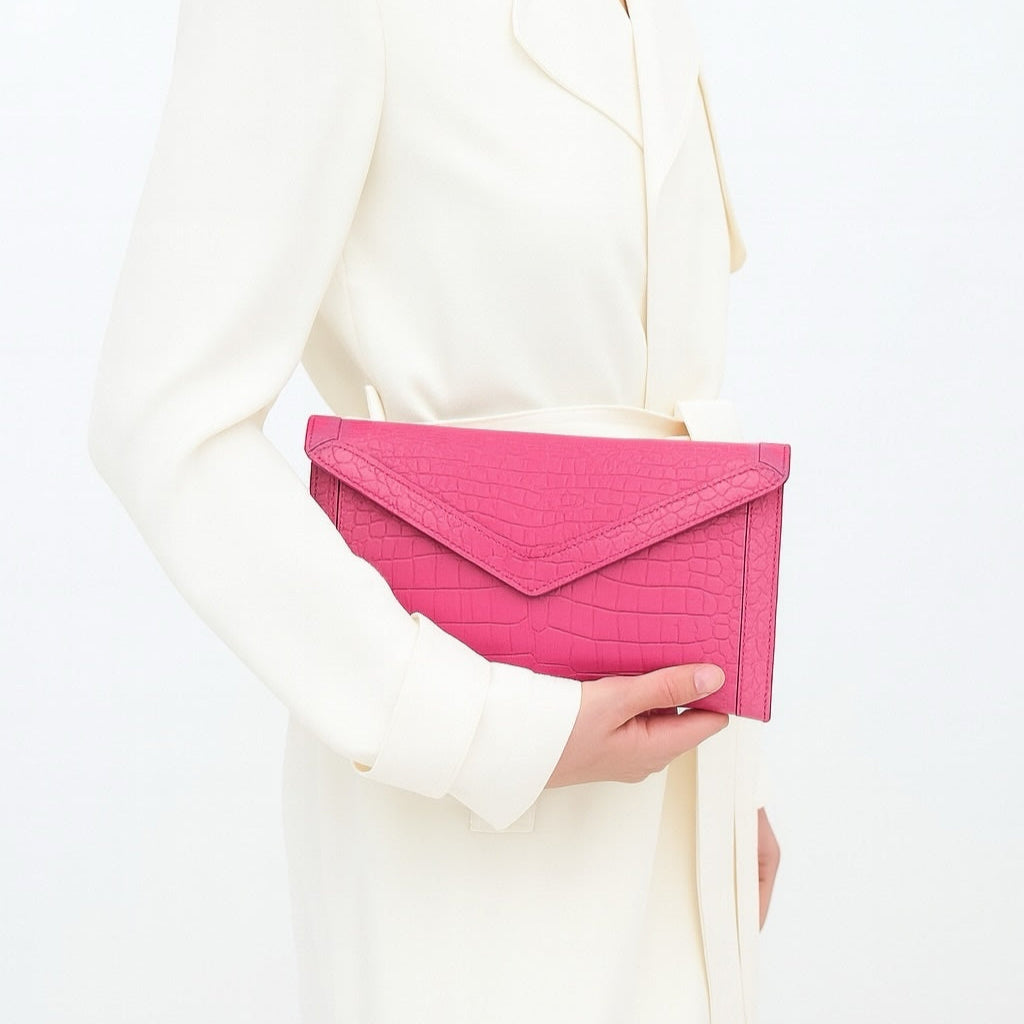 The Morgan clutch is the embodiment of effortless elegance—crafted for the woman who values simplicity without sacrificing luxury. Streamlined yet versatile, its silhouette is large enough to hold your phone and essentials, making it the perfect companion for a day of errands, an evening soirée, or a night on the town.